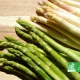 Botte d’asperges vertes et blanches bio sur une planche en bois, avec logo AB